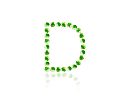 Studio shot of green marbles arranged in Exclamation Point. Photo : David Arky