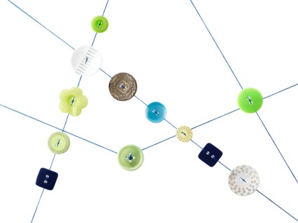 Studio shot of diagram made of thread and buttons. Photo : David Arky