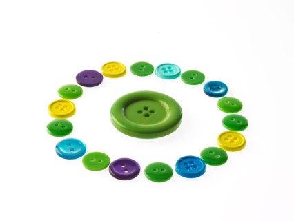 Studio shot of multi colored buttons arranged in circle. Photo : David Arky