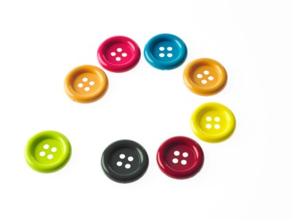 Studio shot of multi colored buttons arranged in circle. Photo : David Arky