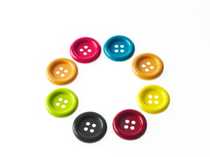 Studio shot of multi colored buttons arranged in circle. Photo : David Arky