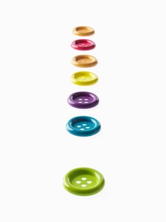 Studio shot of multi colored buttons in a row. Photo : David Arky