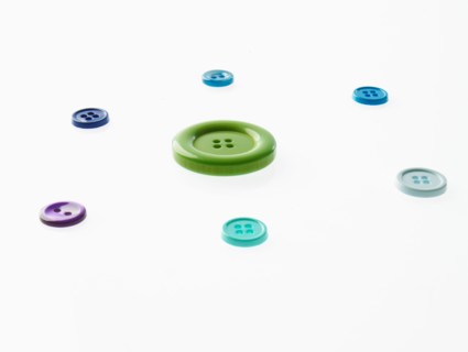 Studio shot of multi colored buttons arranged in circle. Photo : David Arky
