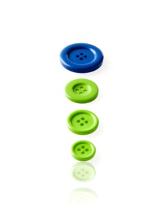 Studio shot of blue and green buttons in a row. Photo : David Arky