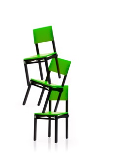 Studio shot of three green chairs stacked one on top of another. Photo : David Arky