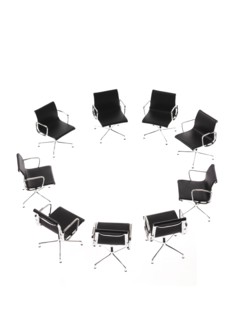 Corporate chairs forming circle on white background. Photo : David Arky