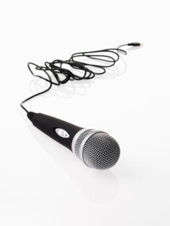 Studio shot of microphone and microphone cable on white background. Photo : David Arky