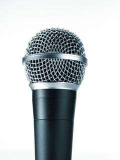 Studio shot of microphone on white background. Photo : David Arky