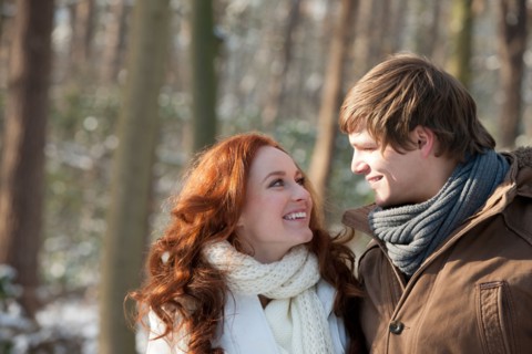 Netherlands, North-Brabant, Hilvarenbeek. Young couple embracing in winter scenery. Photo : Jan