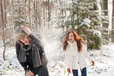 Netherlands, North-Brabant, Hilvarenbeek. Young couple are having snowball fight. Photo : Jan
