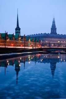 Denmark, Copenhagen. View over canal towards Copenhagen Stock Exchange and Christiansborg Castle.