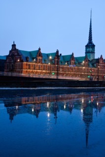 Denmark, Copenhagen. View over canal towards Copenhagen Stock Exchange and Christiansborg Castle.