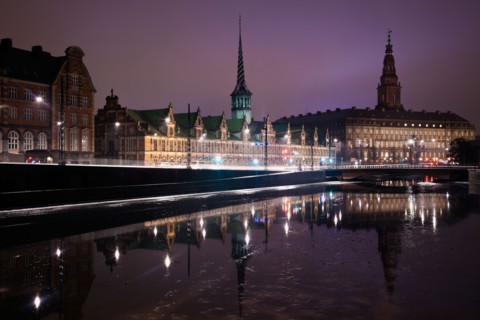 Denmark, Copenhagen. View over canal towards Copenhagen Stock Exchange and Christiansborg Castle.