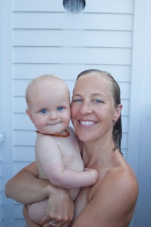 Mid adult woman having shower with her baby son (12-17 months) . Photo : Noah Clayton