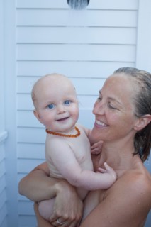 Mid adult woman having shower with her baby son (12-17 months) . Photo : Noah Clayton