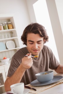 Young man eating. Photo : Rob Lewine