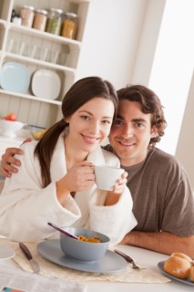 Portrait of young couple at breakfast. Photo : Rob Lewine