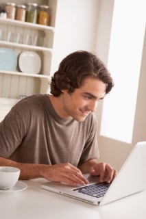 Young man using laptop. Photo : Rob Lewine