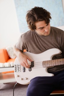 Young man playing electric guitar. Photo : Rob Lewine
