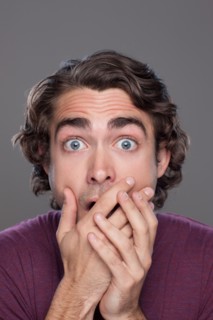 Studio shot of shocked young man. Photo : Rob Lewine