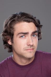 Studio shot of young man frowning forehead. Photo : Rob Lewine
