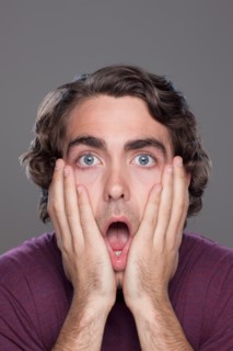 Studio shot of shocked young man. Photo : Rob Lewine