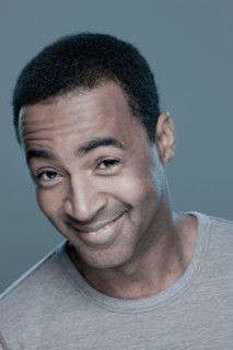 Studio shot of smiling man. Photo : Rob Lewine