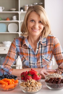 Portrait of mid adult woman with healthy fruits. Photo : Rob Lewine