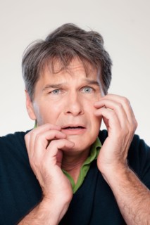 Studio portrait of mature man with facial expression. Photo : Rob Lewine