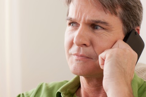 Man talking on phone. Photo : Rob Lewine