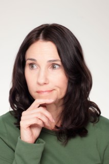 Studio portrait of mature woman with facial expression. Photo : Rob Lewine