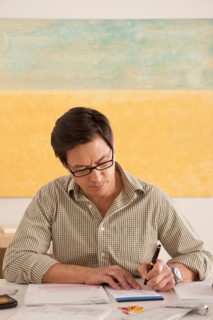 Man doing paperwork. Photo : Rob Lewine