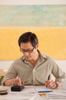 Man doing paperwork. Photo : Rob Lewine