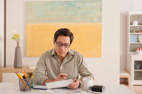 Man doing paperwork. Photo : Rob Lewine