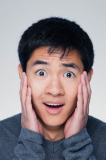 Studio portrait of young man with head in hands. Photo : Rob Lewine