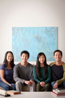Portrait of family sitting on couch. Photo : Rob Lewine