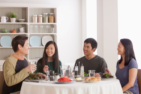 Happy family having meal together. Photo : Rob Lewine