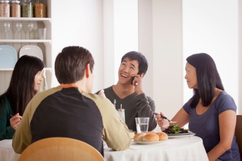 Happy family having meal together. Photo : Rob Lewine