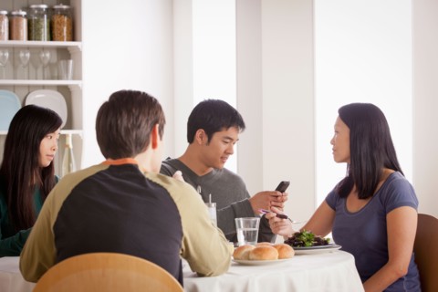 Happy family having meal together. Photo : Rob Lewine