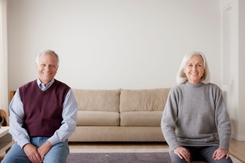 Portrait of senior couple sitting on sofa. Photo : Rob Lewine