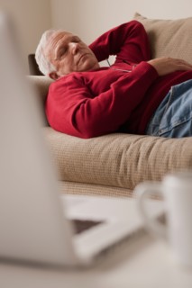 Senior man sleeping on sofa. Photo : Rob Lewine