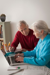 Senior couple working together in home office. Photo : Rob Lewine