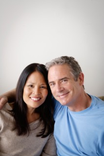 Couple in close embrace sitting on sofa. Photo : Rob Lewine