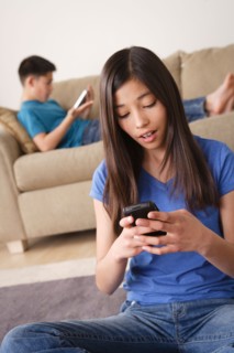 Girl using smartphone. Photo : Rob Lewine