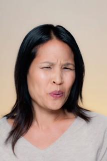 Portrait of woman with disgusted expression. Photo : Rob Lewine