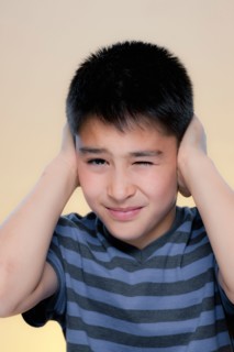 Portrait of boy making displeased expression. Photo : Rob Lewine