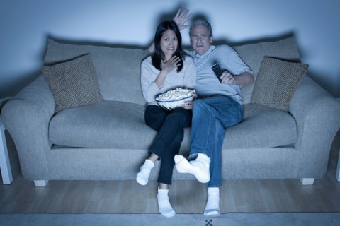 Couple watching television. Photo : Rob Lewine