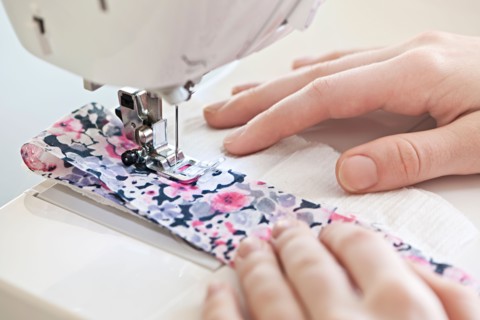 Close-up view of female hands operating machine . Photo : Elena Elisseeva