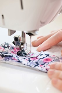 Close-up view of female hands operating machine . Photo : Elena Elisseeva