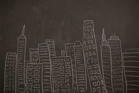 Modern city skyline drawn on blackboard. Photo : Jessica Peterson